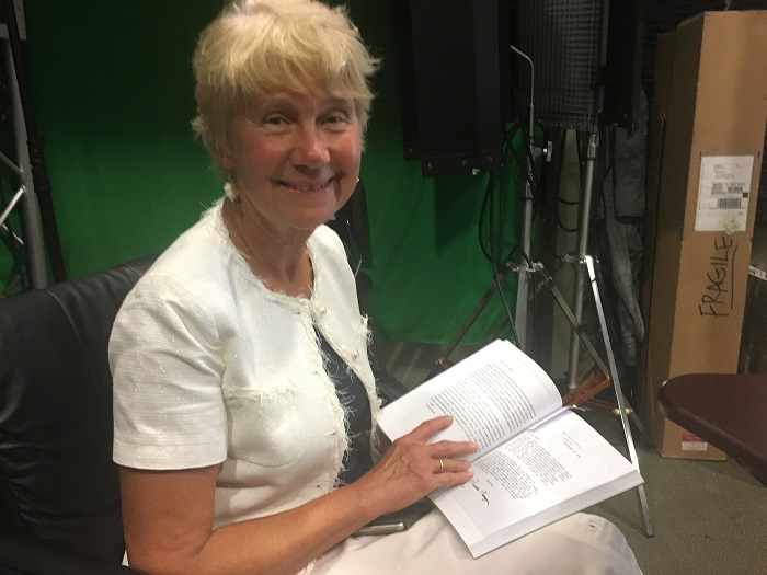 (Mari-Ann Kelam reads a letter she received from President Ronald Reagan. Photo credit: Rev. Ben Johnson.)
