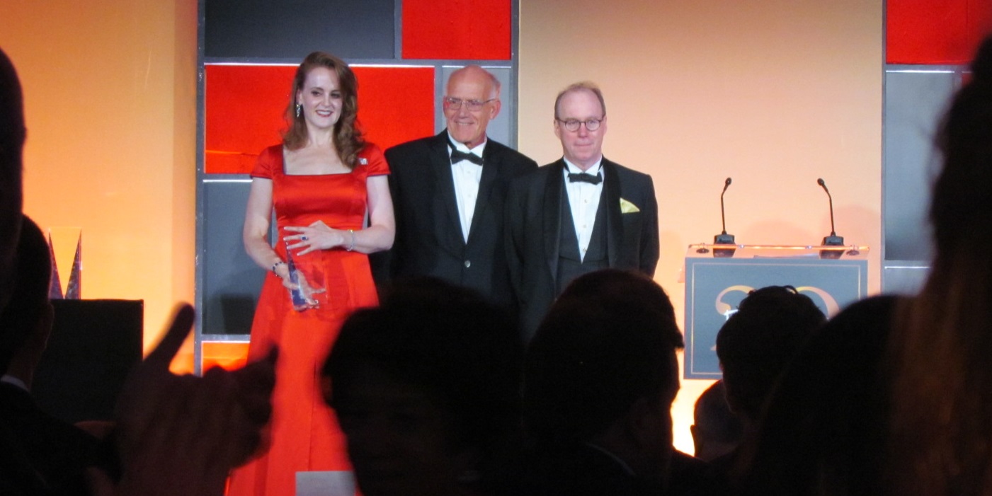 Rebekah Mercer receives her award from Victor Davis Hanson and Roger Kimball.