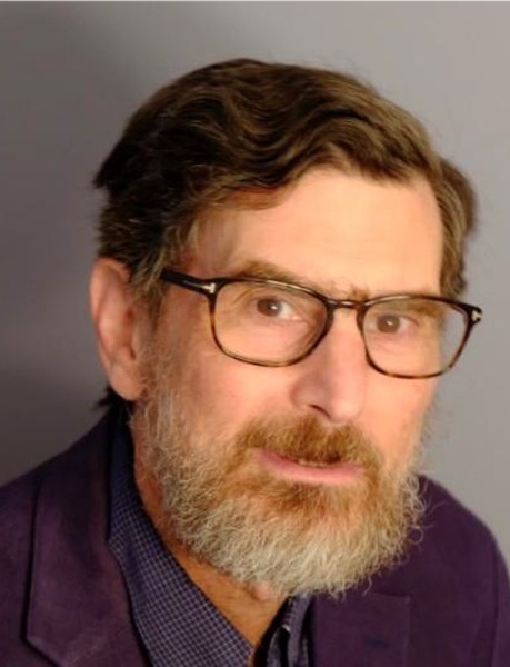 Man with brown hair, dark rimmed glasses, and a brown and gray beard