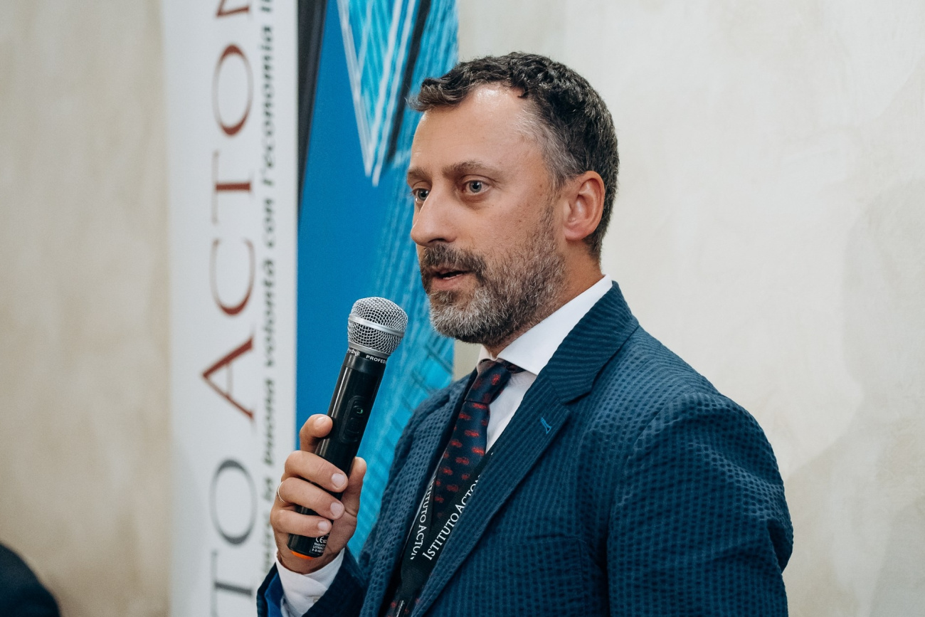 Taras Dzyubanskyy speaking into a microphone at the Acton Convivium